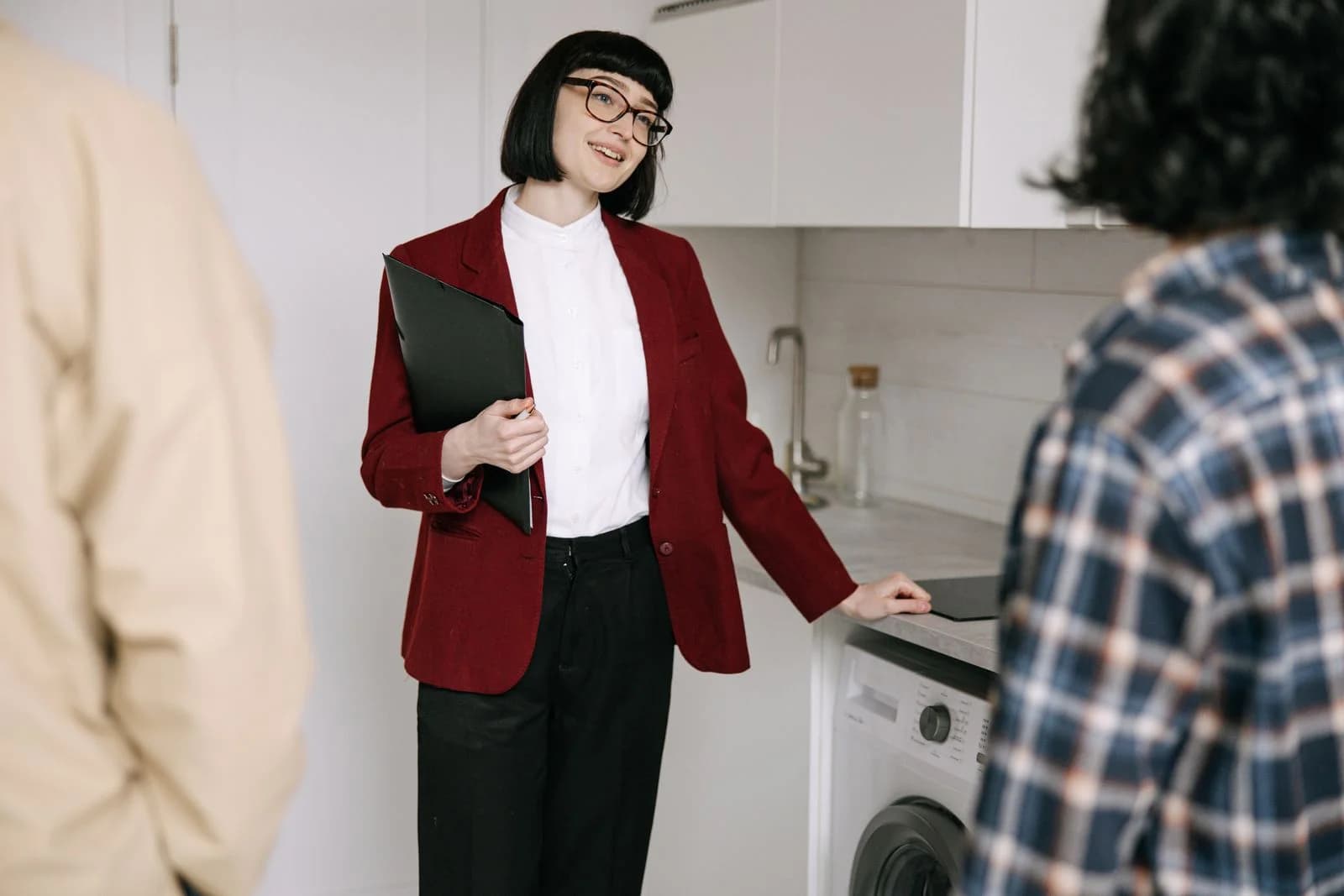 A property representative showing an apartment to prospective customers.